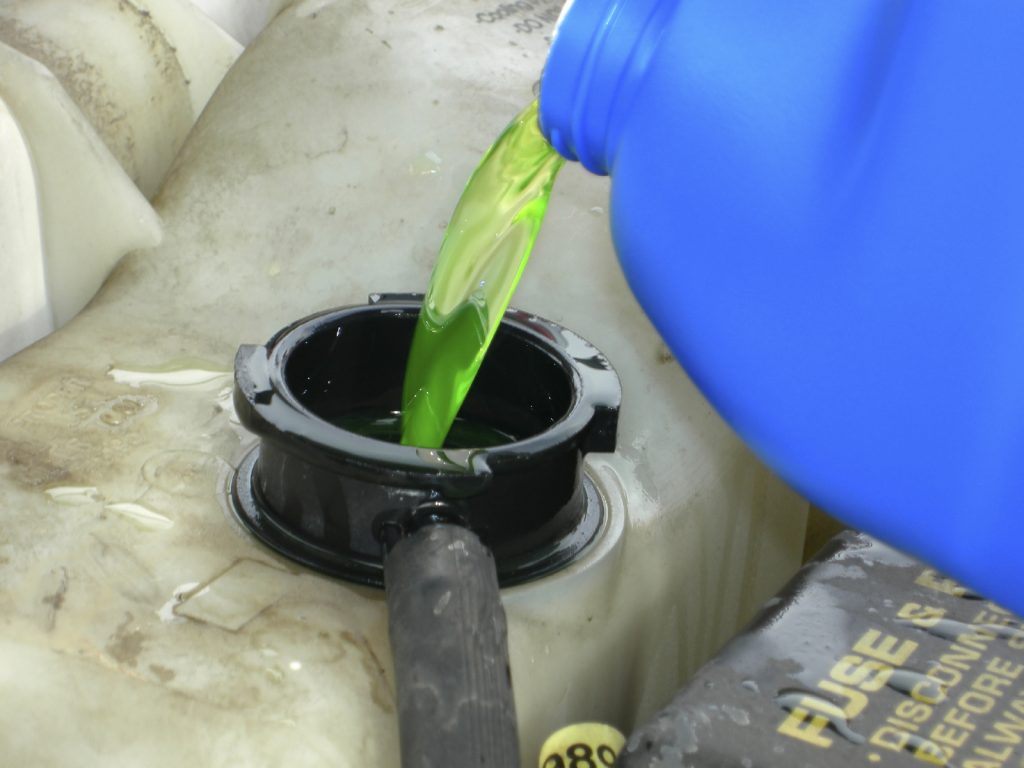 pouring antifreeze into car